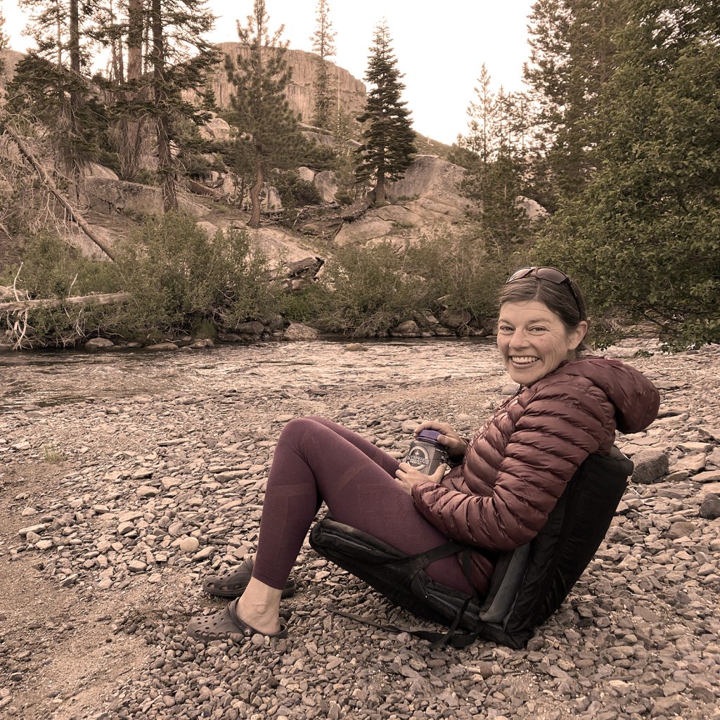 Clair smiling and enjoying a restorative day on the river bank in the PNW. 